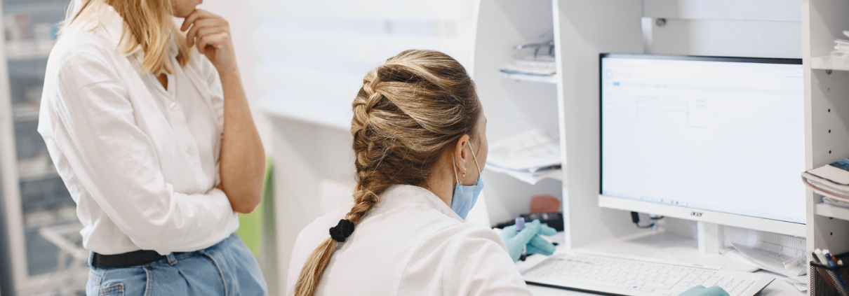 Two medical professionals looking at a computer screen. Header image for an article about finding the best technology solution for medical offices